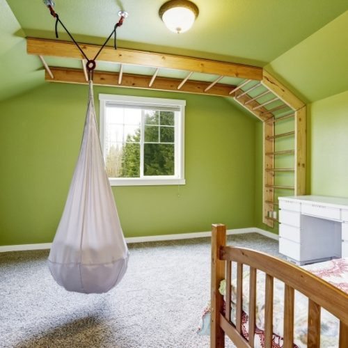 Kids room in bright green with hanging chair